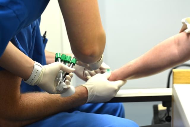 Dr. Myers starts the procedure by drawing a small amount of blood